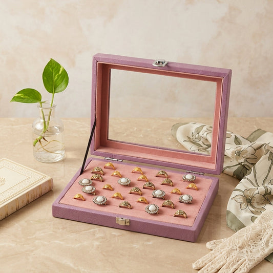Premium lavender ring display box open on wooden table showing blush pink velvet interior with gold pearl rings — Grihosojja Bangladesh